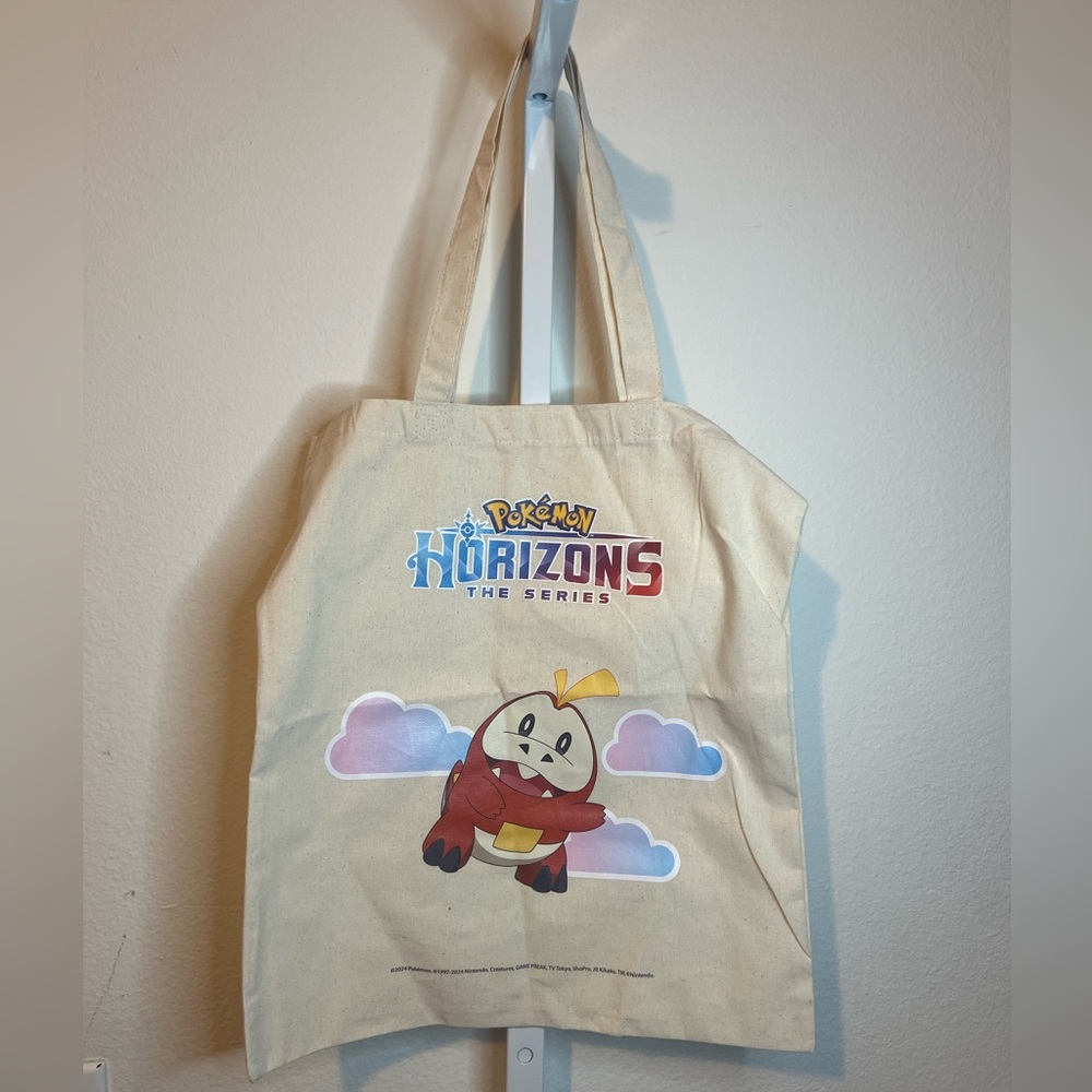 Pokémon Fuecoco and the logo for "Pokémon Horizons: The Series." Tote Bag SDCC